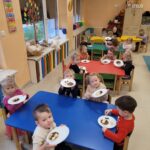 Dzieci prezentują samodzielnie przygotowaną przekąskę w formie "jadalnego misia"