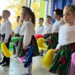 Dzieci wykonują układ choreograficzny z pomponami do piosenki
