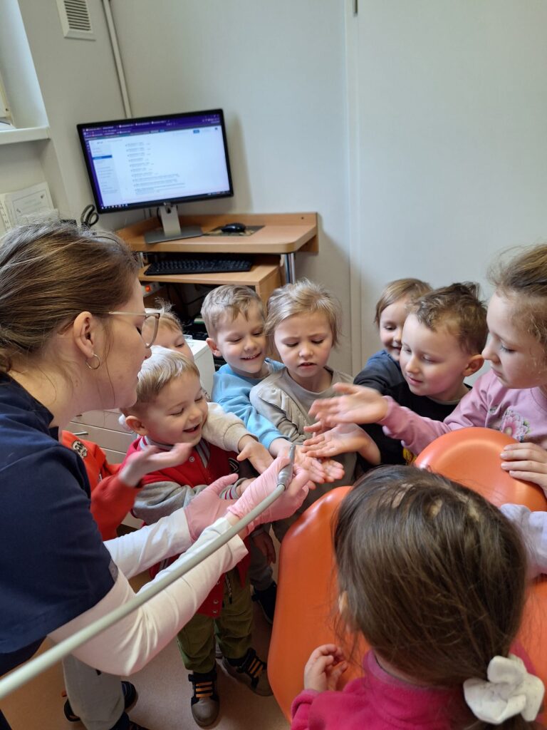 Dzieci oglądają sprzęt stomatologiczny.