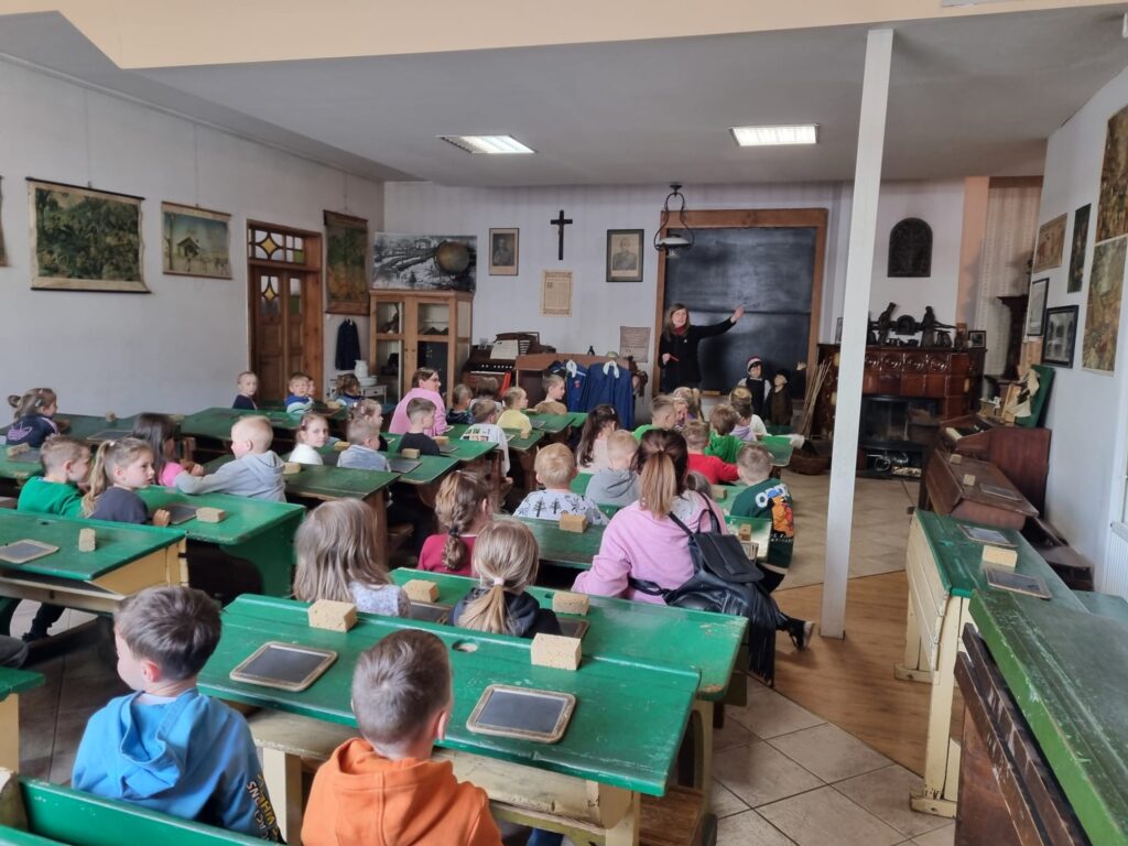 Dzieci siedzą w dawnej szkole.