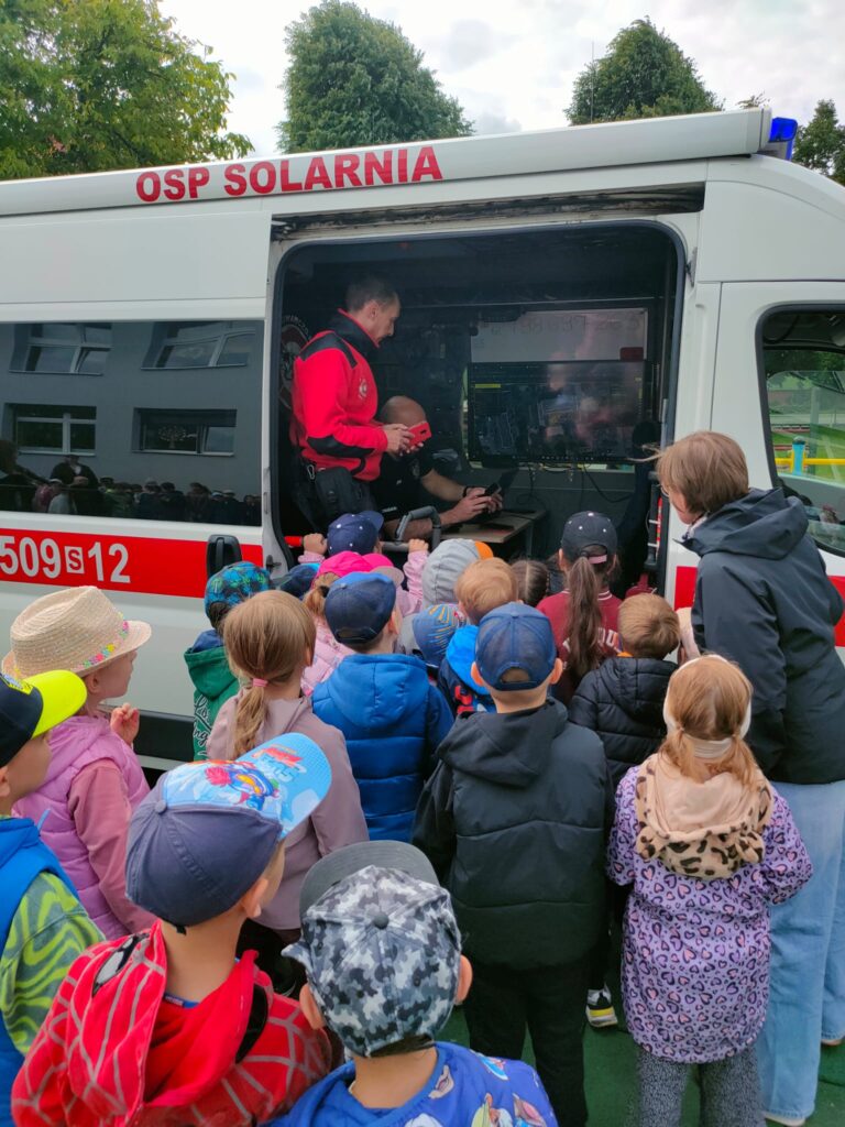 Dzieci oglądają wnętrze wozu operacyjnego.